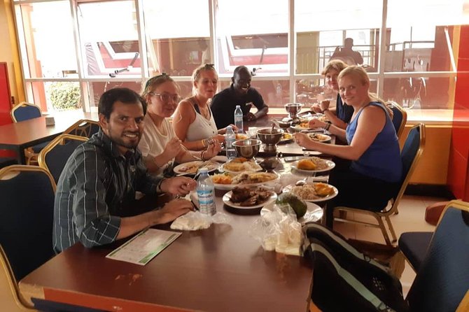 self-drive-eating-spots-uganda - Rent A Driver Uganda Tourists eating food on safari