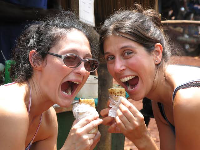 tourists-eating-rolex-uganda - Rent A Driver Uganda Tourists eating rolex in Uganda